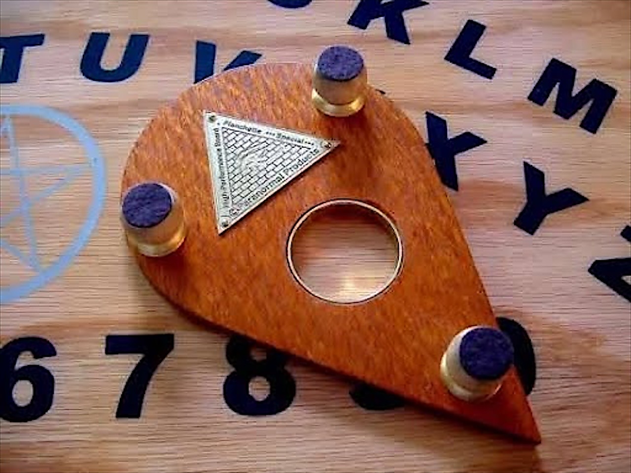 The pointer planchette on a board
